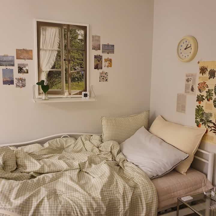 Beige-toned bedroom featuring gingham bedding and multiple pillows creating a cozy ambiance