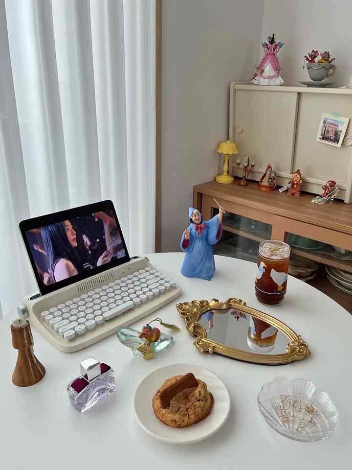 White tone dining room featuring Disney objets and a round table with coffee, creating a cozy home cafe space