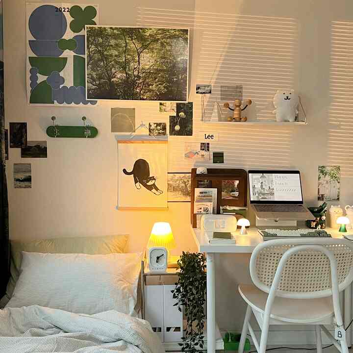 Natural-toned small bedroom with warm yellow lighting featuring a white desk in a simple home office setting