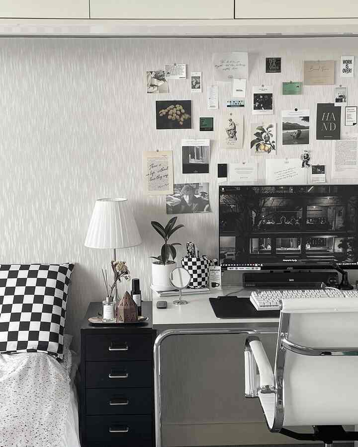 Monotone black and white small studio home office with checkered cushion, desk and office chair arranged in a simple workspace