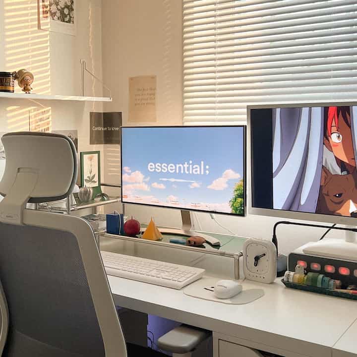 White-toned home office space featuring dual monitors and an office chair in a neat workspace interior