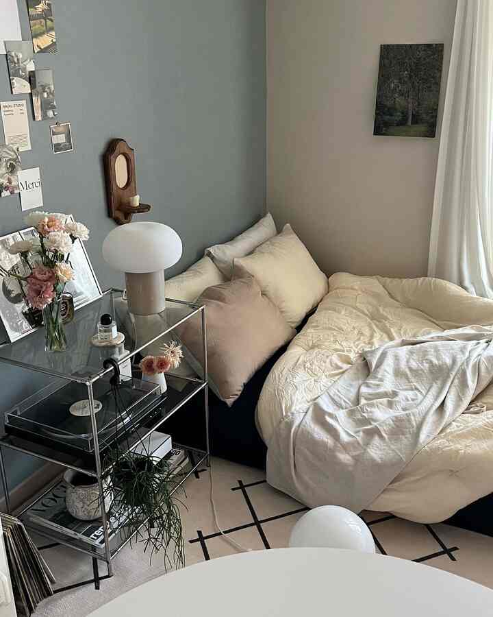 White and gray toned studio bedroom featuring pillows and duvet creating a cozy atmosphere
