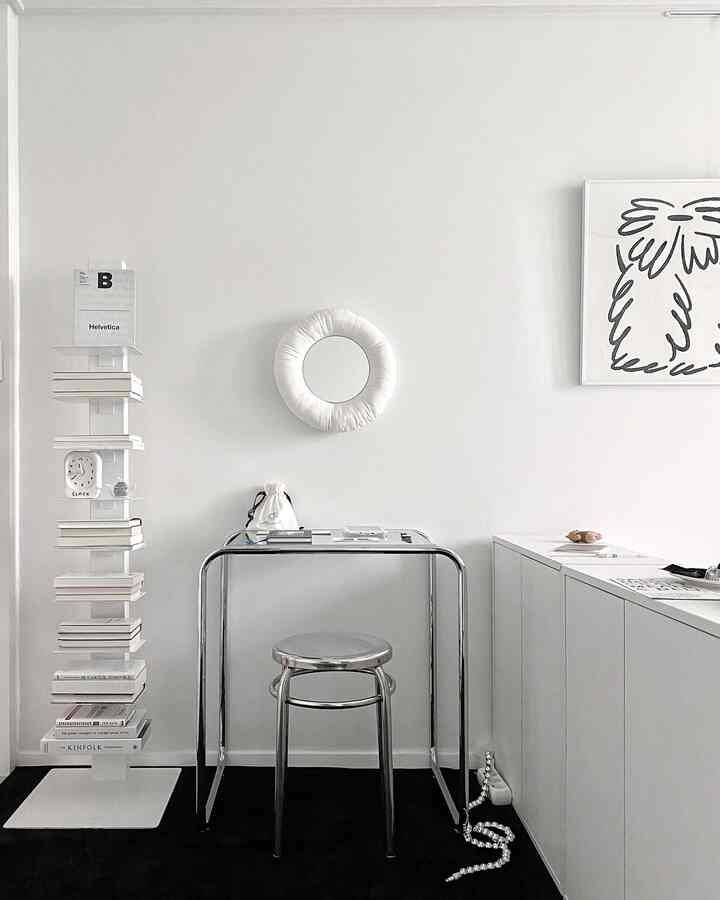 White and silver minimal space featuring a transparent desk and stool with a sleek home office vibe