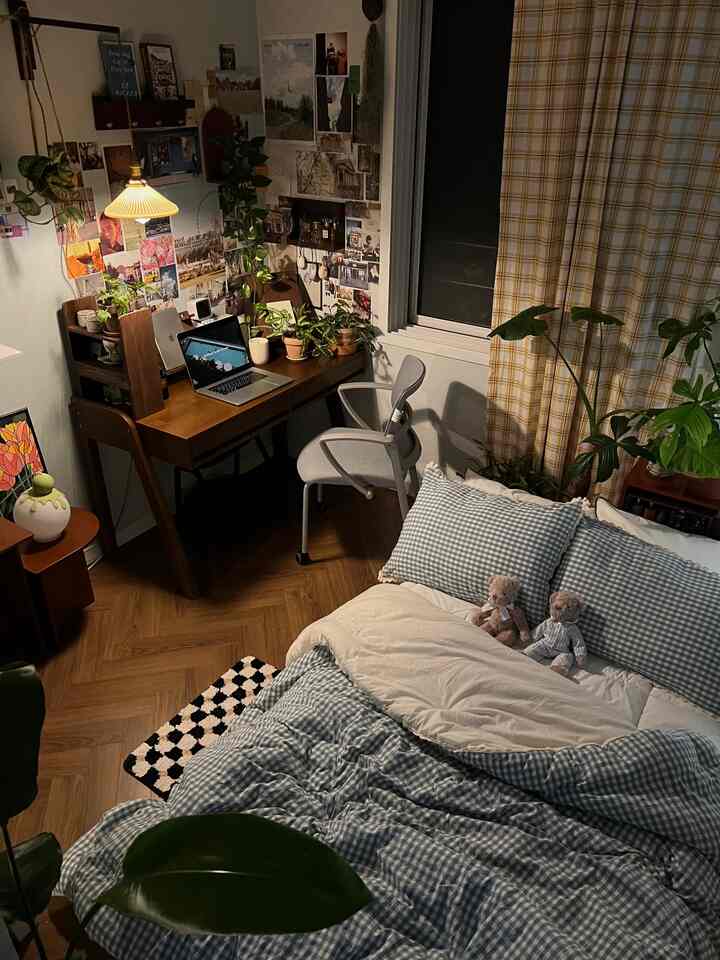 Blue and yellow toned bedroom with wooden desk and gray chair, cozy single household space