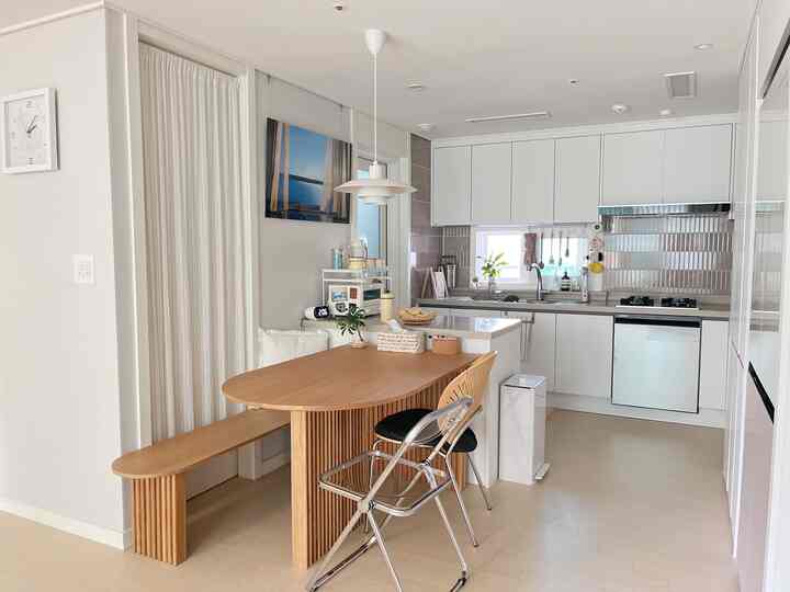 White and wood-tone small kitchen dining room featuring simple, clean design creating a sense of openness