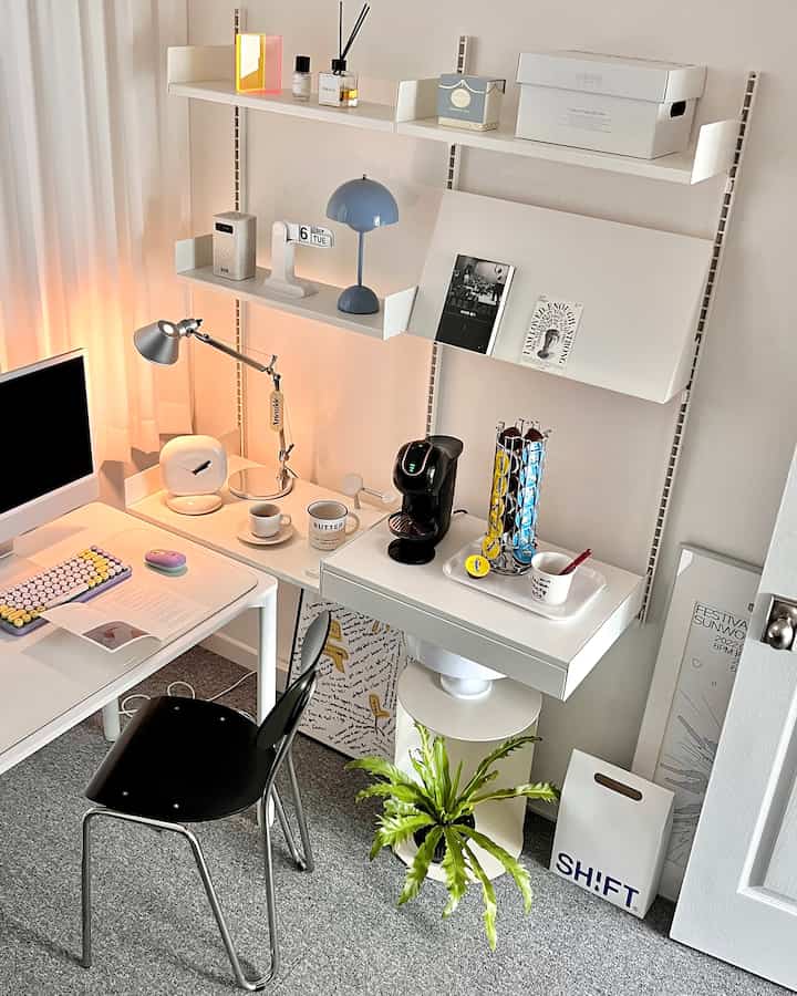 White-toned, minimalist home office space featuring desk, chair, shelving with a neat and cozy atmosphere