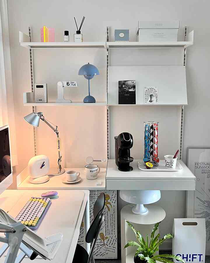 White-toned home office space featuring a clean desk and coffee machine creating a functional work area