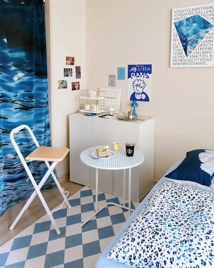 Blue and white toned bedroom featuring compact furniture and blue patterned bedding creating a cozy atmosphere
