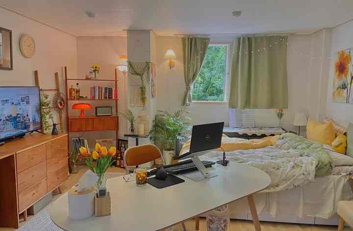 Natural-toned bedroom and desk arranged in a cozy and functional remote work space