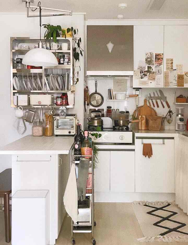 White and natural toned kitchen featuring diverse storage ideas and gap storage creating a cozy atmosphere