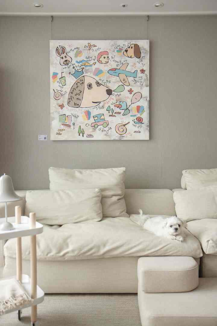 Natural beige toned living room with large 4-seater sofa featuring a small dog lying comfortably, simple modern atmosphere