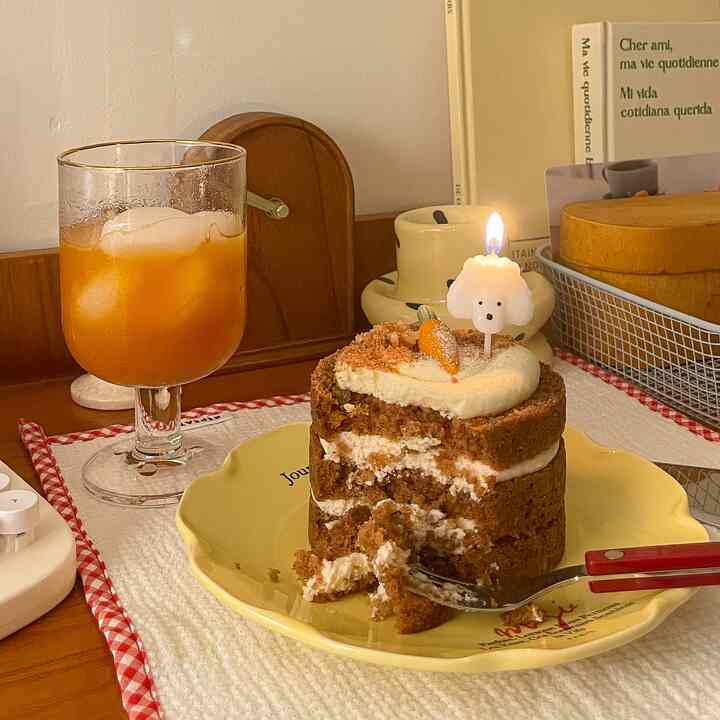 Cozy home cafe dining area featuring a yellow plate and transparent cup with gold rim on wooden table