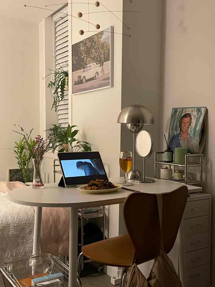 White and brown toned 6-tatami bedroom and dining space featuring simple modern table, chairs, lamp, and plants creating a cozy atmosphere