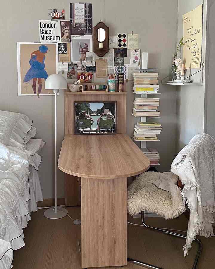 Natural color beige-walled bedroom home office featuring wooden desk, stool, and wall art creating a cozy atmosphere