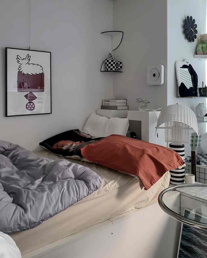 Monotone and beige bedroom featuring a neat bed, wall shelf, and picture frame with a modern atmosphere