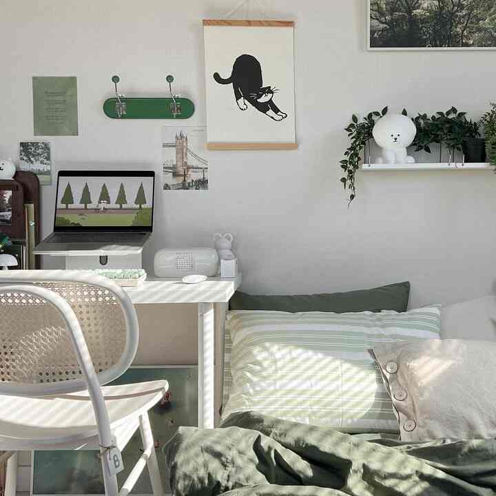 Natural tone bedroom featuring desk with rattan chair, bed and plants creating a cozy space