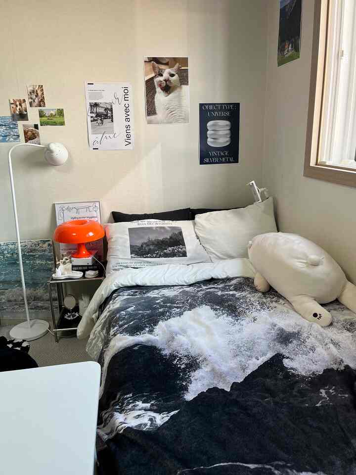 White and black toned 6-tatami bedroom featuring a bed, wall decor, and cozy cat-themed elements