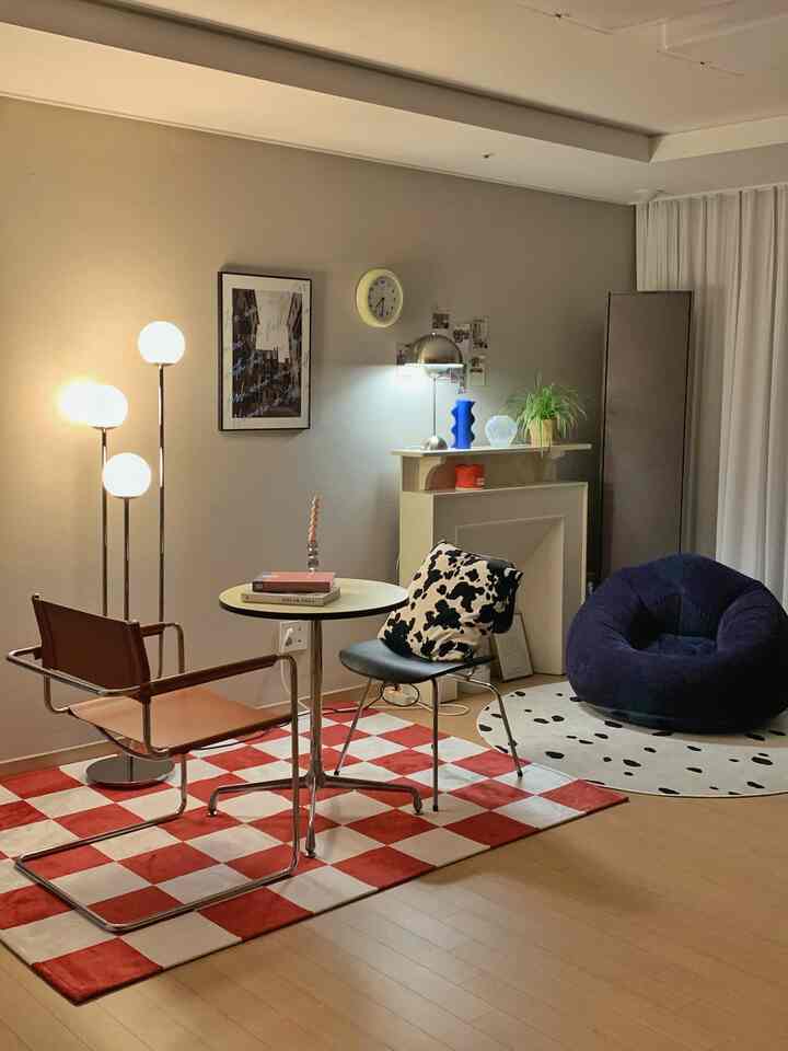 Bright living room featuring red checkered rug and mid-century modern furniture with cozy atmosphere