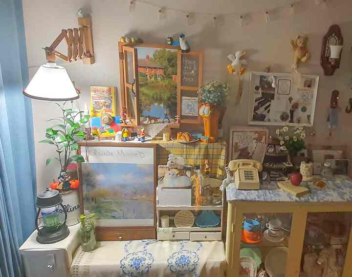 Vintage-style room in beige and yellow tones, featuring various posters and accessories in a cozy, cluttered space