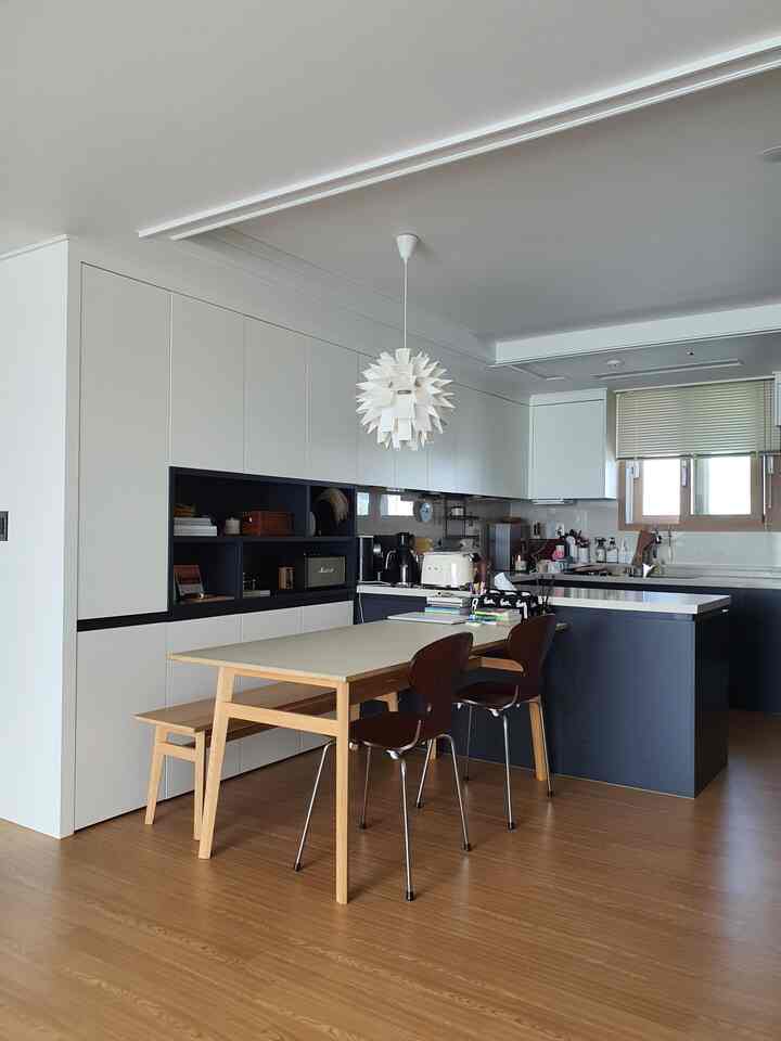 Natural color and wood tone dining room and kitchen featuring dining table, chairs, pendant light with a clean and simple atmosphere