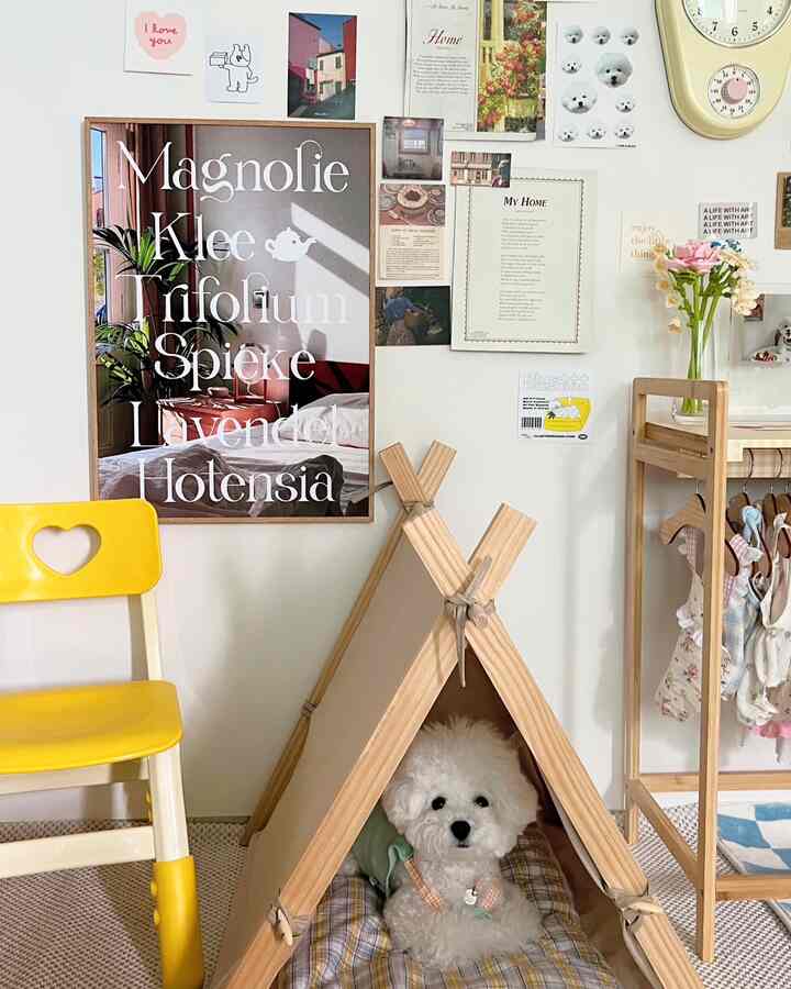 Modern interior with dominant white and wood tones, yellow accent chair, pet tent featuring a white dog and baby clothes rack