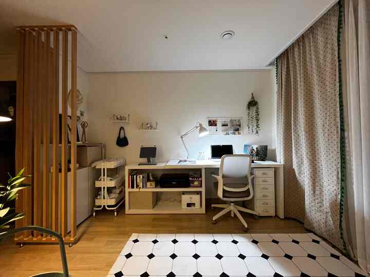 Bright white and wood tone veranda home office space featuring wide desk and office chair in a clean and organized workspace