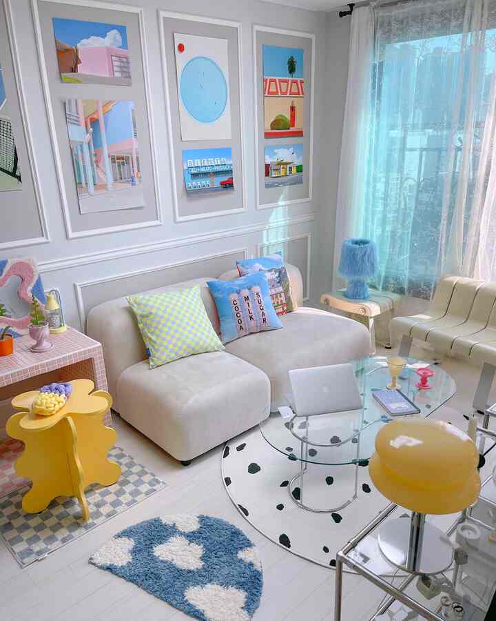 White and blue toned living room featuring a modular sofa, glass coffee table, colorful cushions, and rugs with a fresh feel