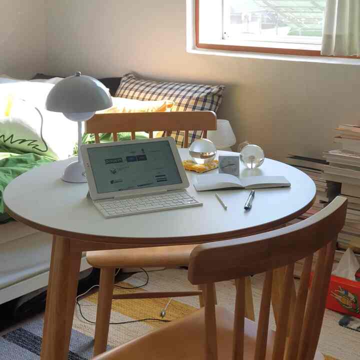 Natural wood tone and white compact home office round table space for two