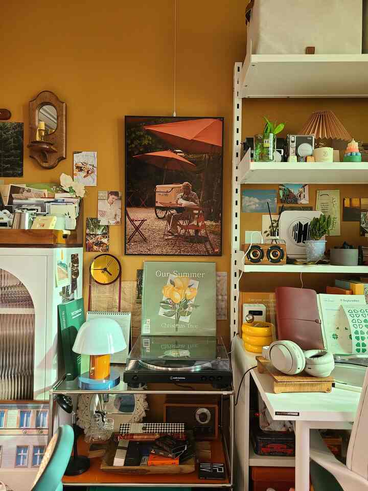 Orange-toned wall vintage studio apartment bedroom featuring an LP player and desk in a cozy interior