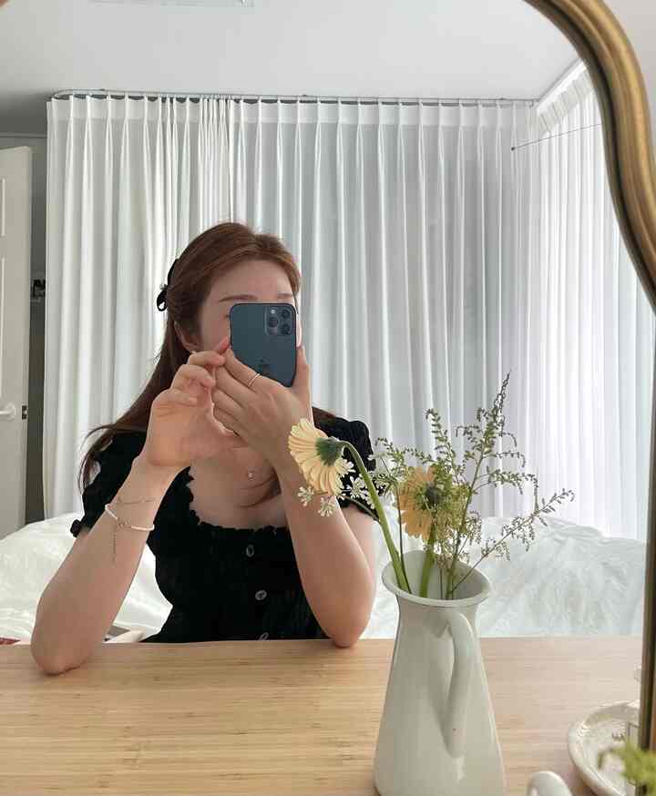 White-toned bedroom with a vanity and chiffon curtains creating a natural and clean space