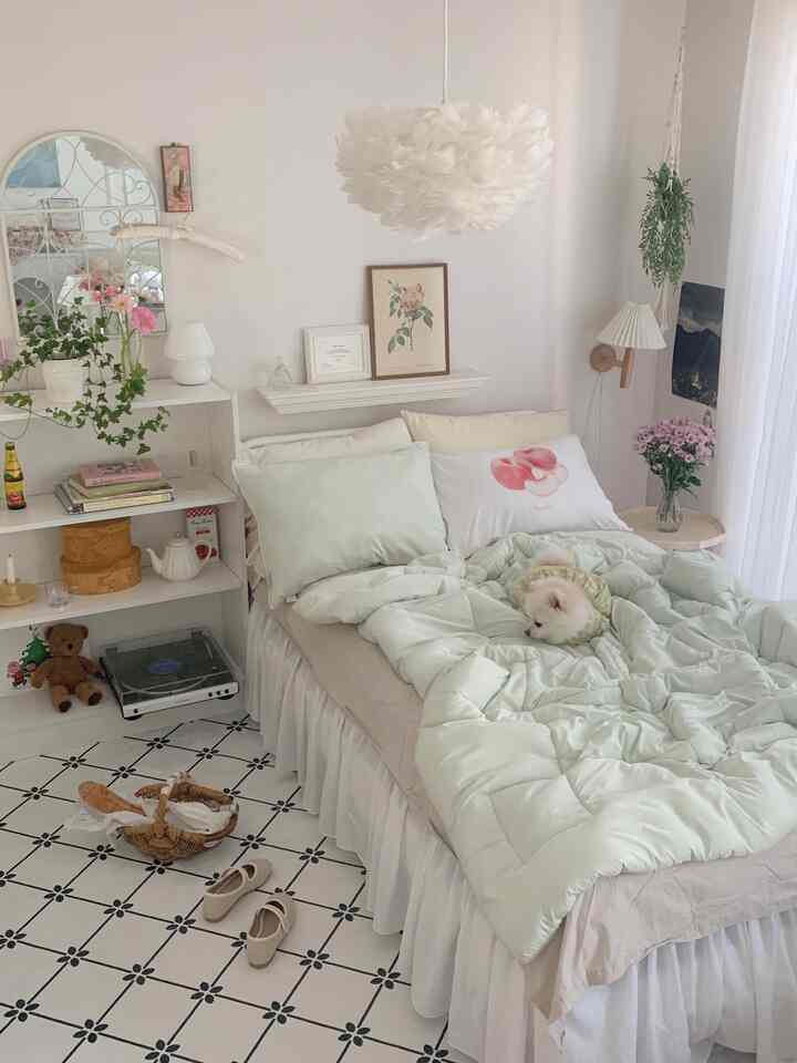 White and natural toned bedroom featuring bed with pillows and duvet, cozy space with a pet dog lying on the bed
