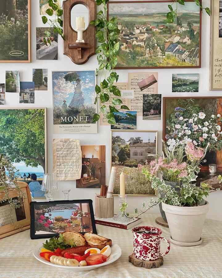 Natural toned dining space with diverse posters and potted plants featuring cozy home cafe-style accessories on the table