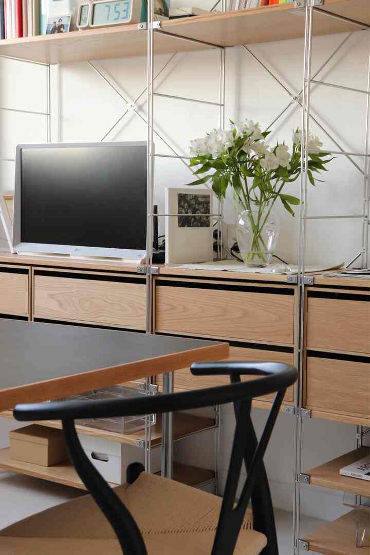 Natural modern home office with white walls and wood tone storage cabinets creating a harmonious workspace