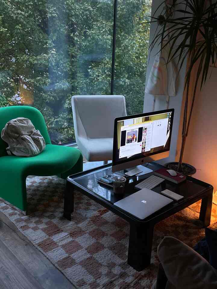 Living room with black table and green sofa, modern and warm atmosphere