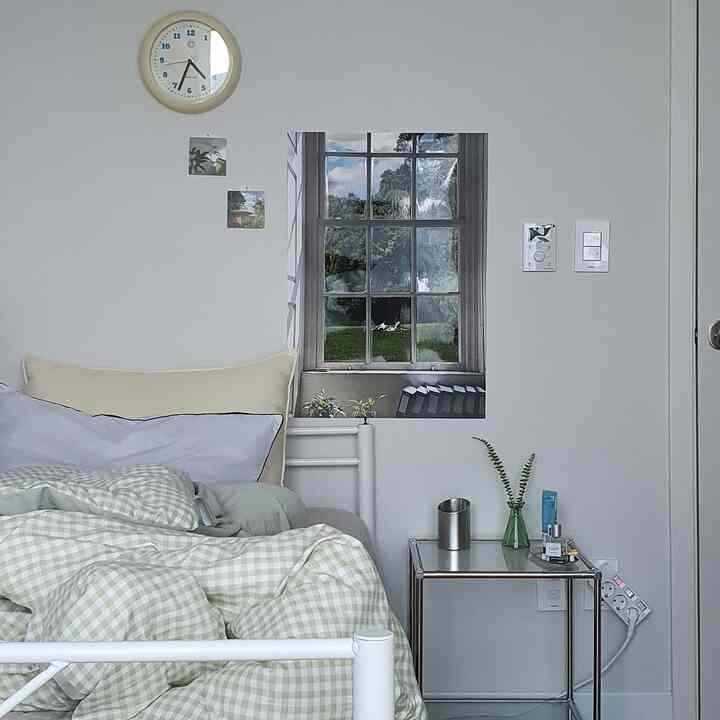 白い壁とナチュラルなグリーンチェックの寝具が配置された4.5畳の寝室、シンプルで落ち着いた雰囲気のインテリア