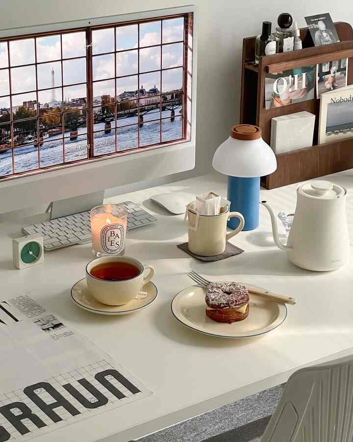 White and brown toned home office desk featuring electric kettle and tea cup, creating a clean and cozy home cafe space
