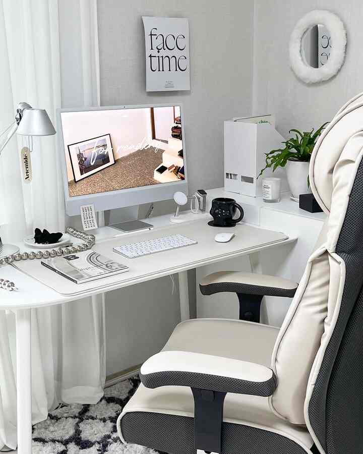 White and gray toned home office featuring a large iMac and ergonomic office chair with modern, simple interior design