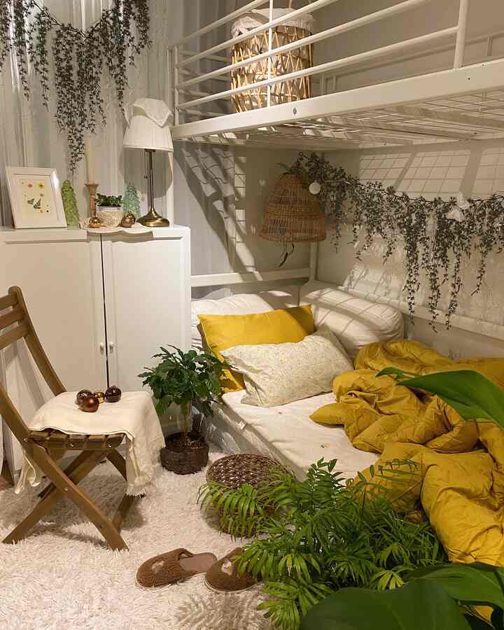 Ivory and natural-toned 6-tatami bedroom featuring a white bed with yellow bedding, wooden chair, and various plants creating a cozy atmosphere