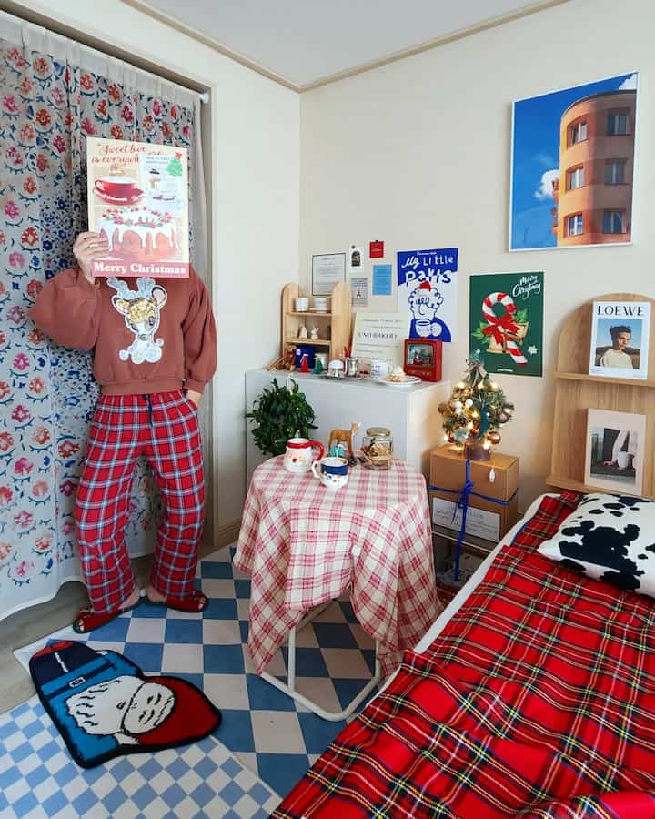 Red and white toned living room featuring Christmas decorations and tartan tablecloth creating a cozy atmosphere