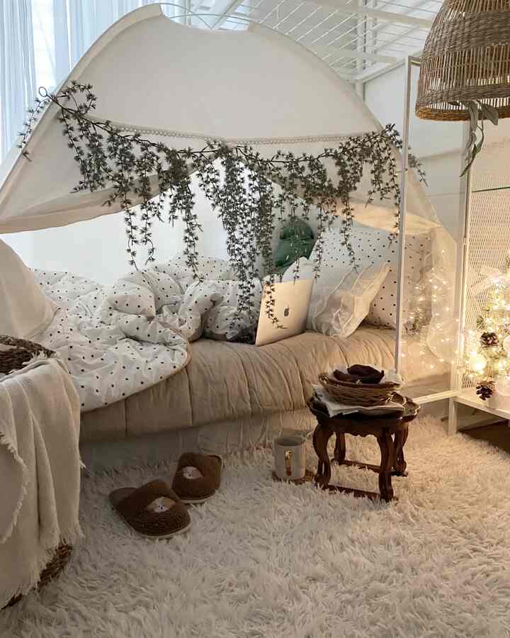 White and beige toned bedroom featuring polka dot bedding and wooden table with a cozy natural atmosphere