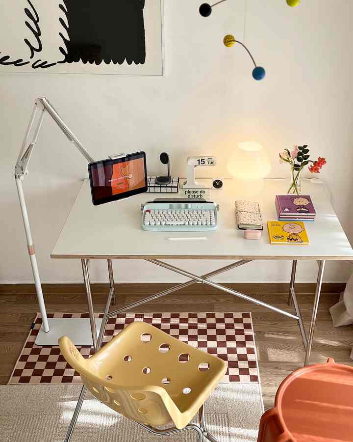 White and wood tone home office space featuring an adjustable iPad stand and vintage-style keyboard on a neat desk
