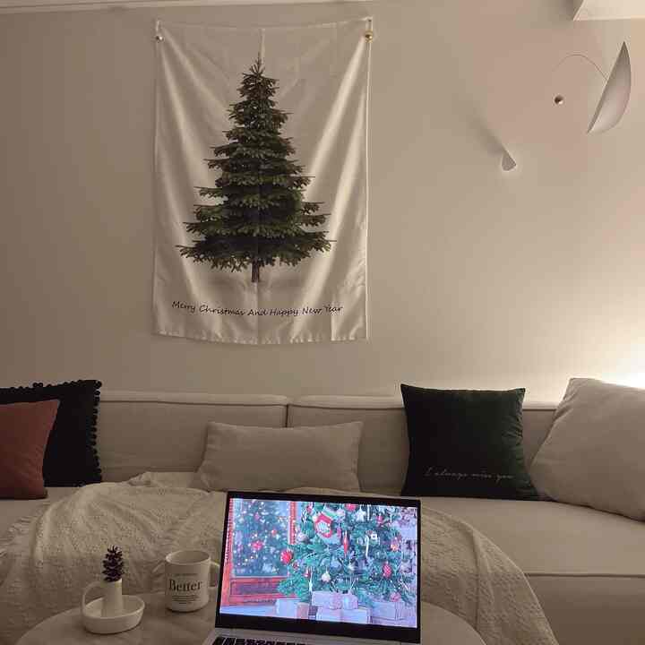 White and green toned living room featuring a Christmas tree poster and cozy sofa setting