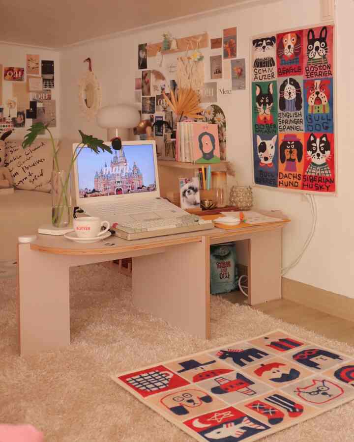 Beige and natural toned small loft room featuring cute dog-themed mats and a cozy desk setup for work