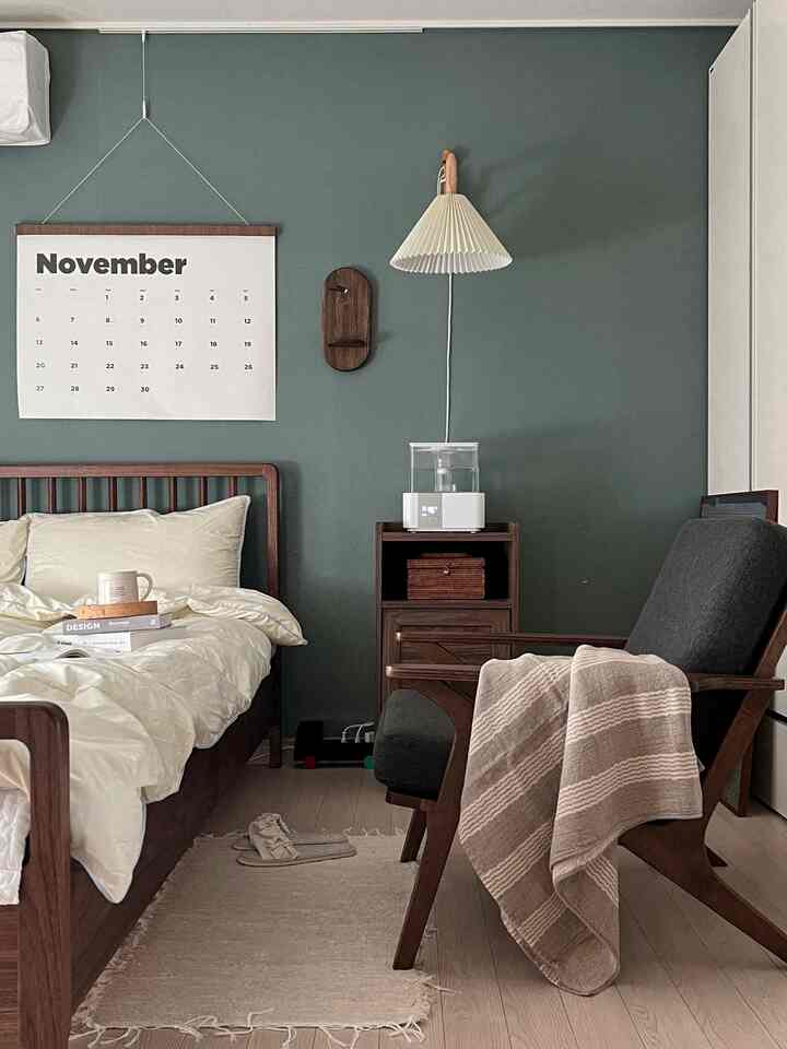 Wood tone and beige bedroom featuring a wooden bed and armchair in a warm, natural ambiance