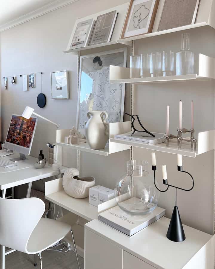 White and beige toned home office study featuring iMac, shelves, and minimalist design elements