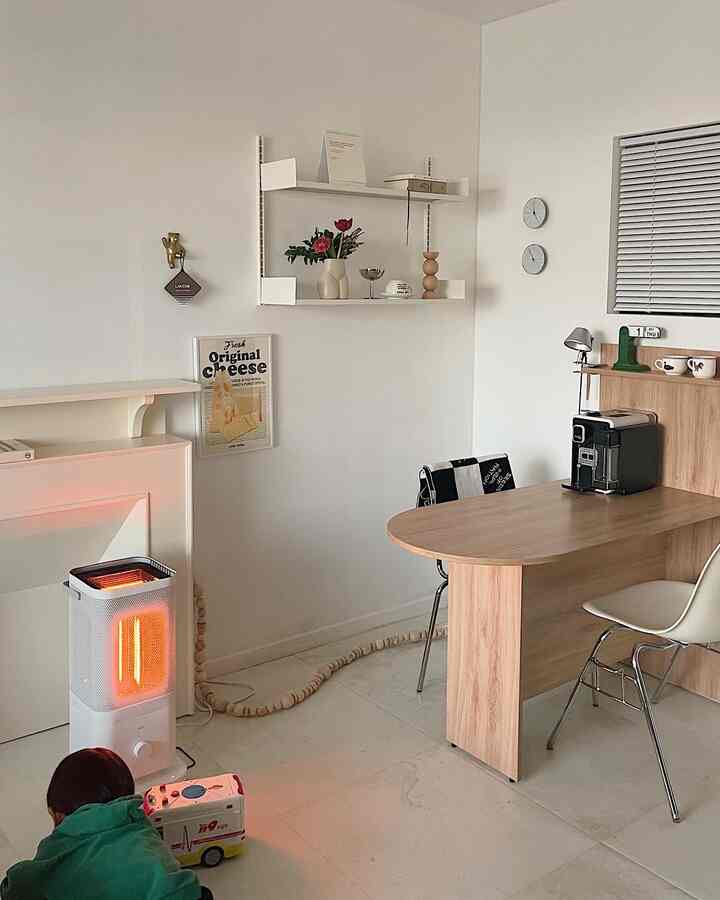 White-walled dining room with wood-tone furniture, dining table and chairs, heater creating a cozy atmosphere in a child-friendly space