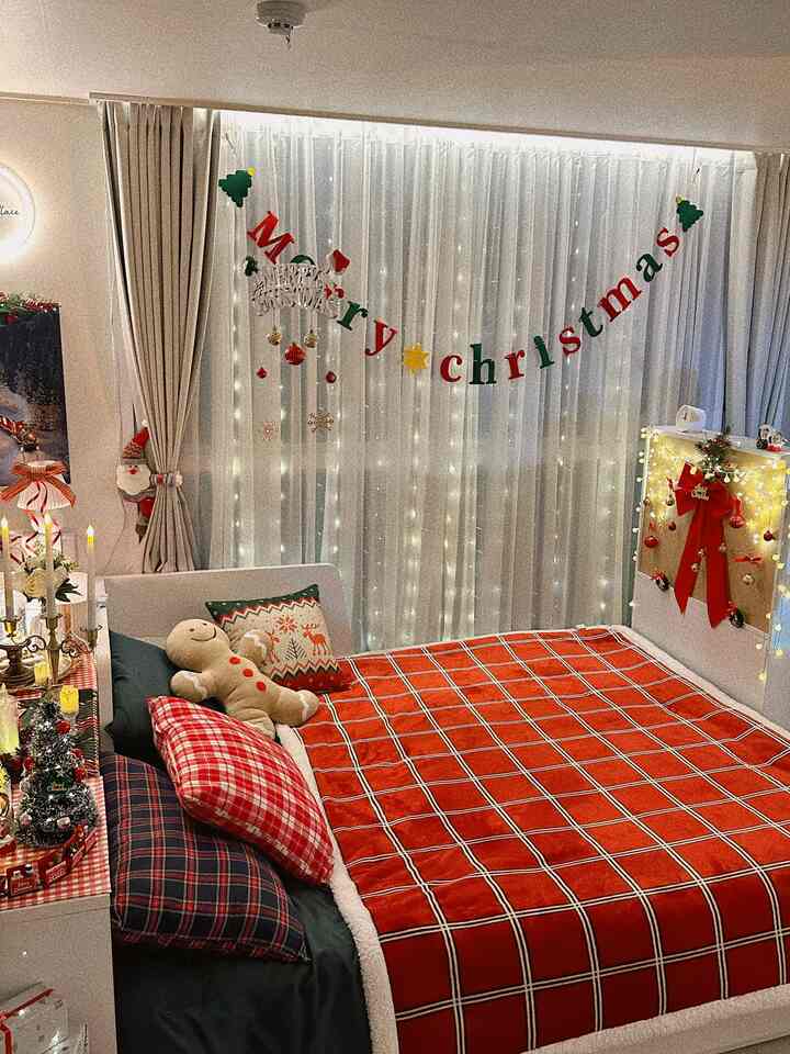 White and red toned bedroom featuring Christmas decorations and a cozy red check blanket