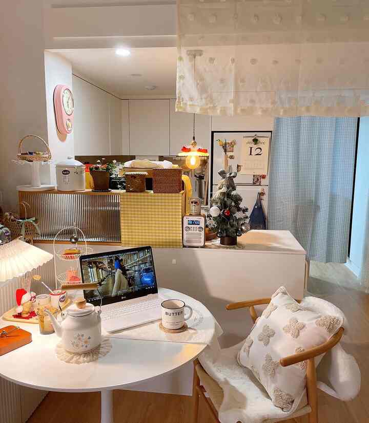 White and beige toned 6-tatami kitchen and dining room with natural modern style featuring a wood chair and home cafe setup on the table