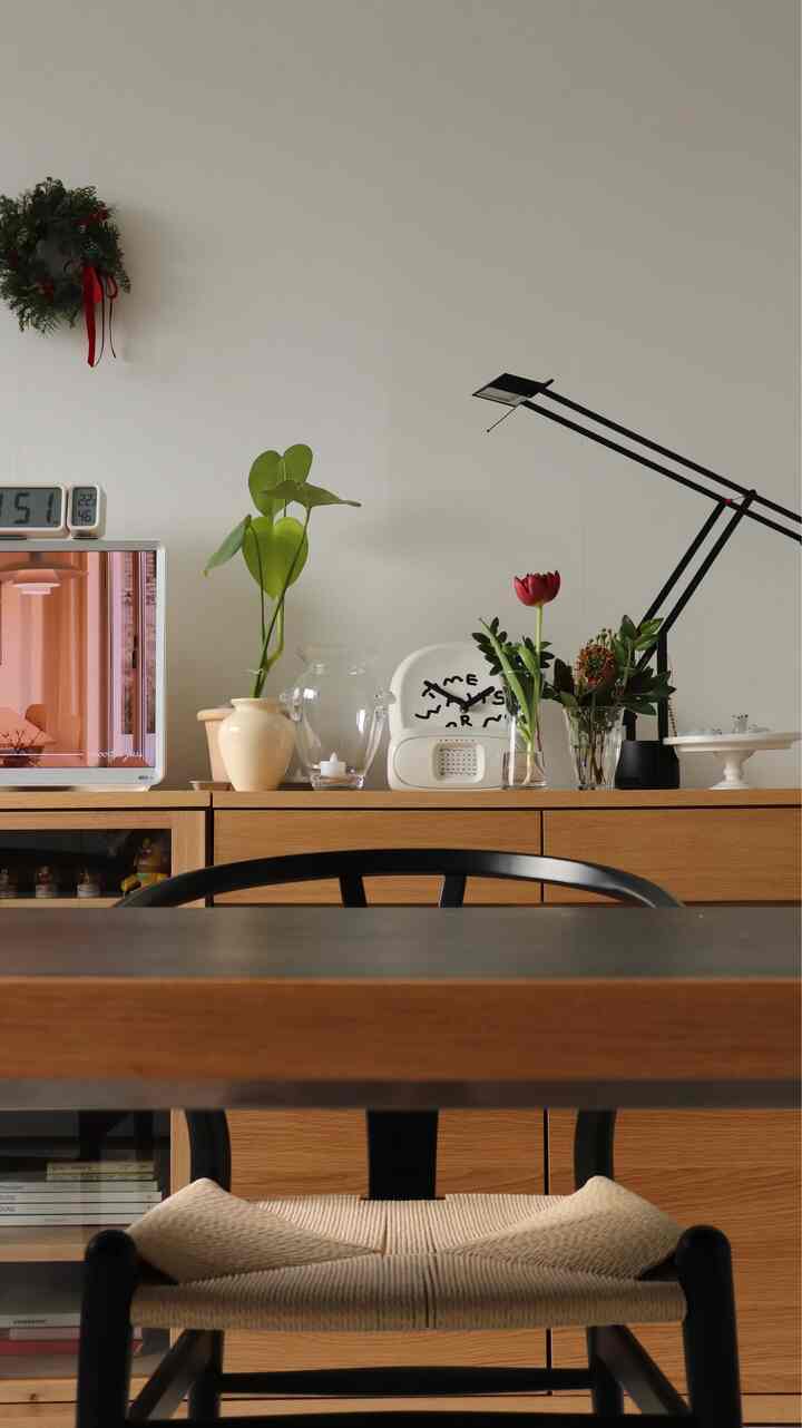 Natural-toned dining room featuring wooden dining table and rattan chair with a warm atmosphere