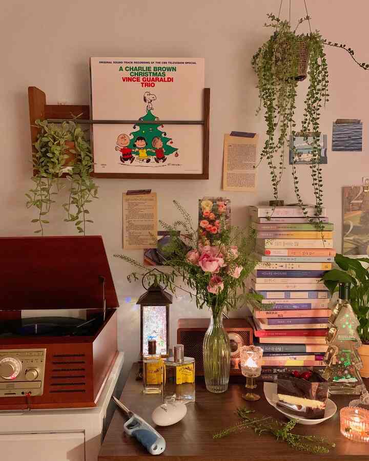 Cozy living corner with warm wood tones, vintage decor, and lush plants creating intimate atmosphere